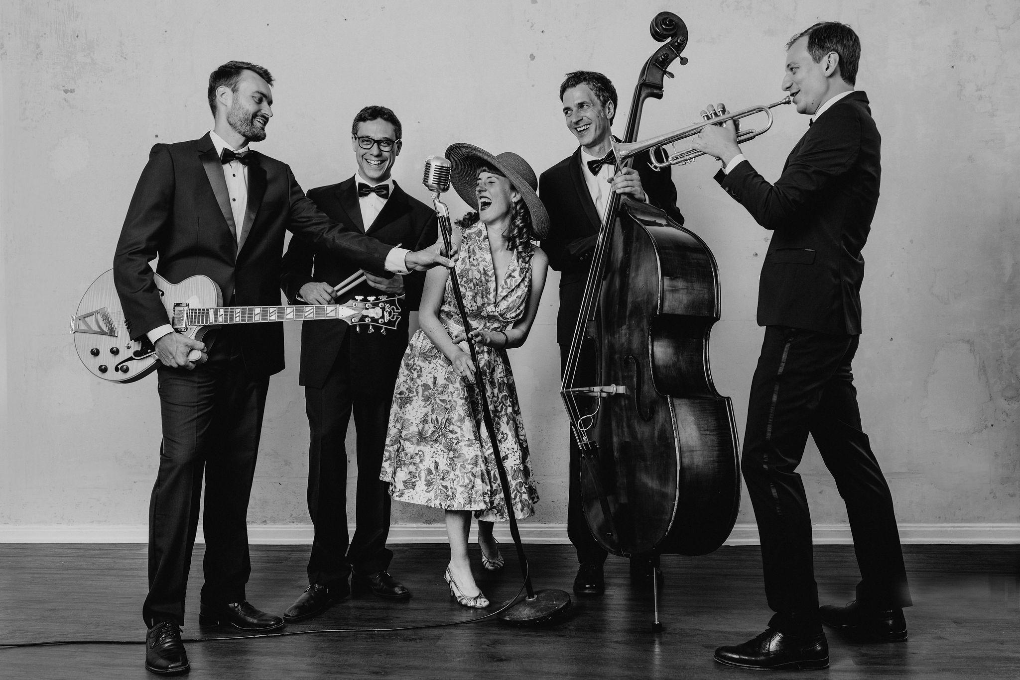 Professionelle und stilvolle Live-Band mit Sängerin, Gitarristen, Bassisten, Schlagzeuger und Trompeter bei einem Firmenevent.